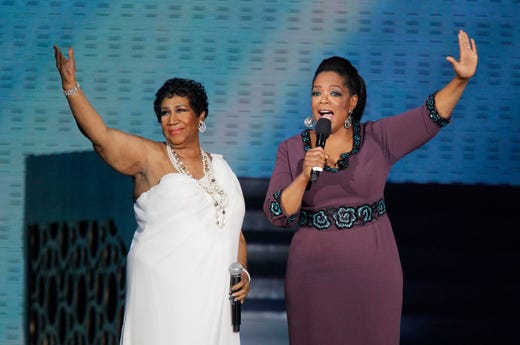Aretha Franklin and Oprah Winfrey acknowledge fans during a star-studded double-taping of "Surprise Oprah! A Farewell Spectacular," Tuesday, May 17, 2011, in Chicago. "The Oprah Winfrey Show" is ending its run May 25, after 25 years, and millions of her fans around the globe are waiting to see how she will close out a show that spawned a media empire. (AP Photo/Charles Rex Arbogast)