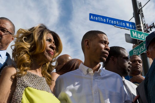 Aretha Franklin and her son Kecalf Cunningham stand under the newly unveiled street sign in front of the Music Hall in Detroit, June 8, 2017. (David Guralnick/Detroit News via AP) ORG XMIT: MIDTN102