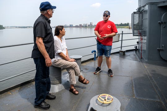 James Homan, from left, and Belen Dorsett of Tell City, Ind., listen to their tour guide Brady Bolinger give animated facts about the USS LST-325 in Evansville, Ind., Tuesday, Aug. 14, 2018. On Monday night, Evansville City Council approved nearly $2.8 million to relocate the ship from Marina Pointe to Downtown Evansville. 