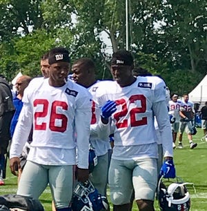 NY Giants running backs Saquon Barkley, left, and Wayne Gallman, right, walk off the field following Tuesday's joint practice with the Detroit Lions in Allen Park, Mich.