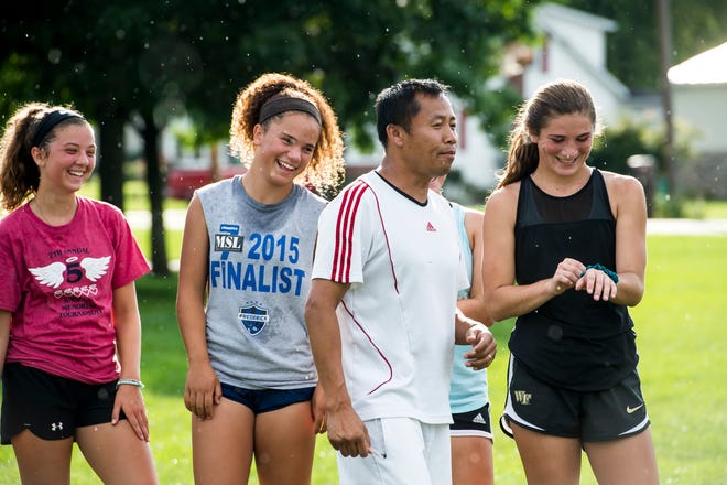 Fairfield girls soccer head coach Phomma Phanhthy makes his players laugh during the first day of fall sports practice on Monday, August 13, 2018. 