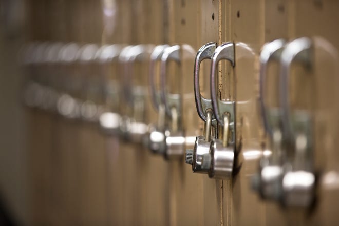 A high school custodian in Bloomington was suspended after a camera was discovered in a locker room.
