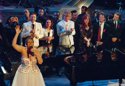 FILE - In this April 28, 1993 file photo, Aretha Franklin, foreground left, performs in the finale of "Aretha Franklin: Duets," an AIDS benefit concert for the Gay Men's Health Crisis in New York, as singers Smokey Robinson, background from left, Gloria Estefan, Rod Stewart, Bonnie Raitt and actors Dustin Hoffman and Robert De Niro look on. A person close to Franklin said on Monday that the 76-year-old singer is ill. Franklin canceled planned concerts earlier this year after she was ordered by her doctor to stay off the road and rest up. (AP Photo/Ron Frehm, File) ORG XMIT: NYET908