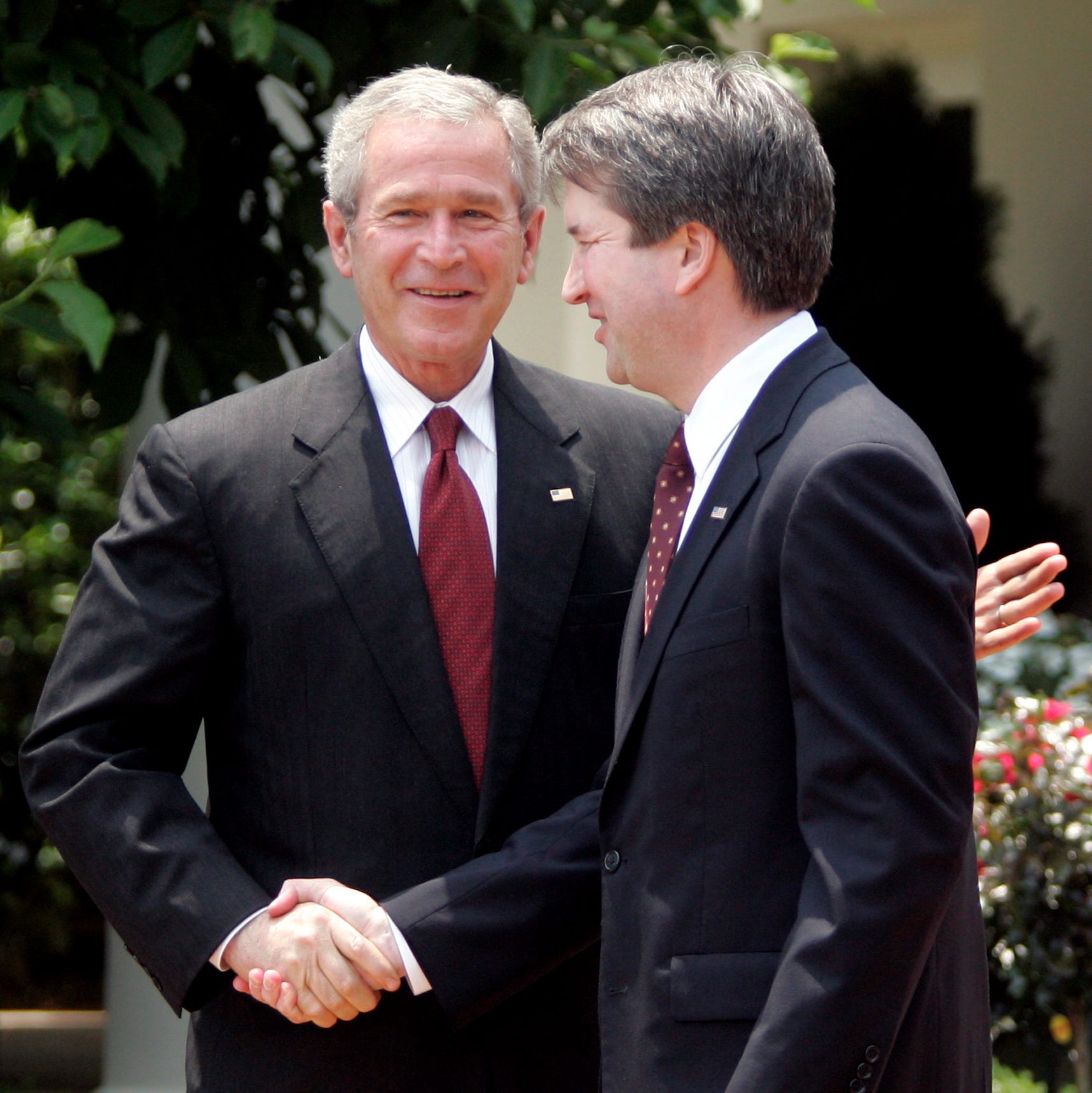 President George W. Bush  congratulates Brett Kavanaugh after he was sworn in as a federal appeals court judge at a White House ceremony on June 1, 2006. Kavanaugh previously served as White House staff secretary.