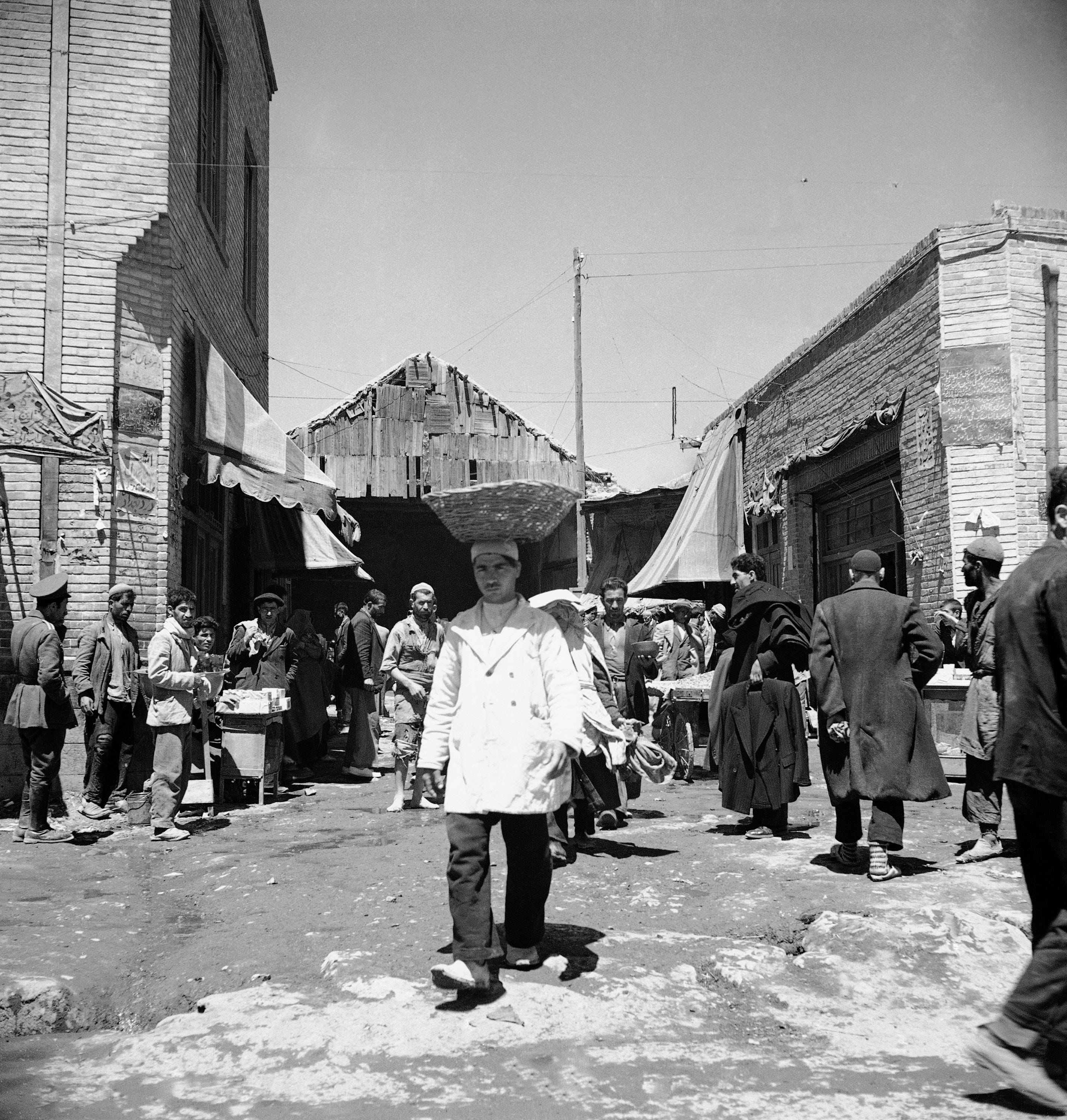 A man carries a basket on his head near the Southern Bazaar in Tehran, Iran on April 20, 1946.  