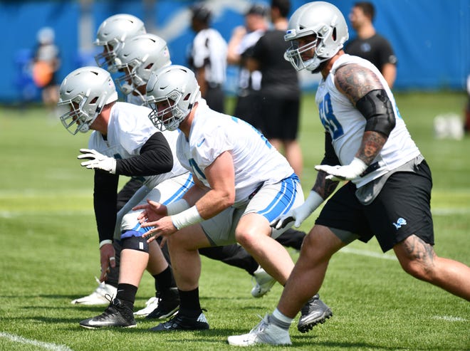 Lions offensive linemen Graham Glasgow, Frank Ragnow and Taylor Decker work during drills in June.