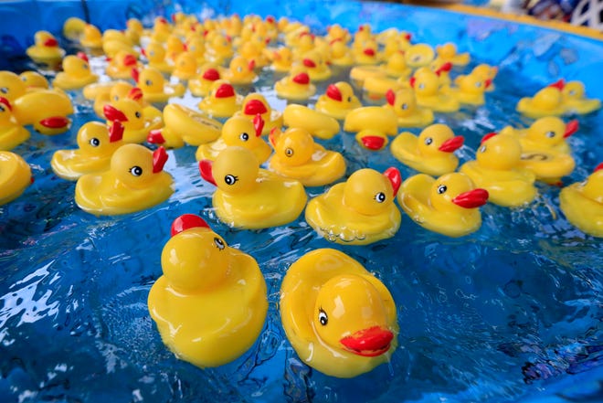 Rubber duckies float in a pool as carnival games are set up on the opening day of the Brown County Fair on Wednesday, August 15, 2018 in De Pere, Wis.