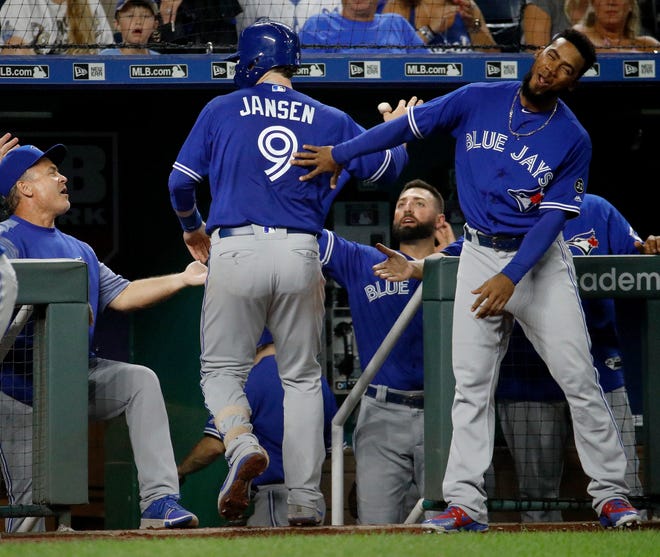Toronto's Danny Jansen is congratulated by teammates after hitting his first major league home run on Tuesday against the Kansas City Royals.