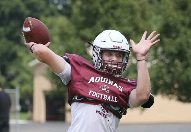 Aquinas quarterback Tyler Szalkowski airs it out during the teams  practice at Aquinas Institute in Rochester  Wednesday, Aug. 15, 2018. 