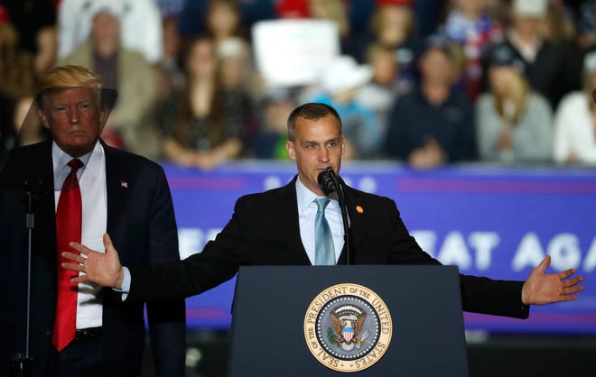 Corey Lewandowski, with President Donald Trump at his side, speaks during a campaign rally in Washington Township, Mich., in April.