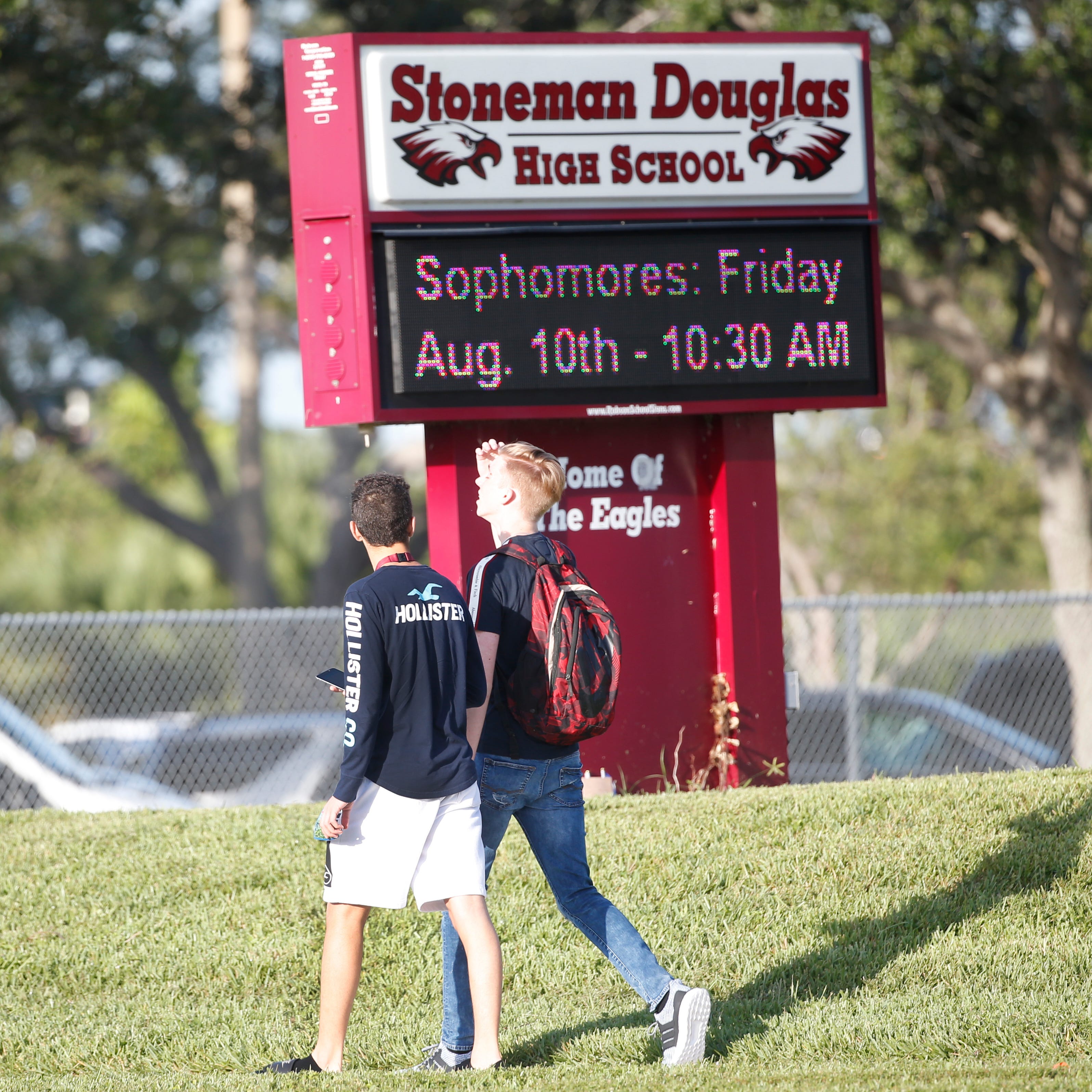 Students walk to class at Marjory Stoneman Douglas High School, Weds., Aug. 15, 2018, in Parkland, Fla. Students at the school returned Wednesday, to a more secure campus as they began their first new school year since a gunman killed 17 people in th