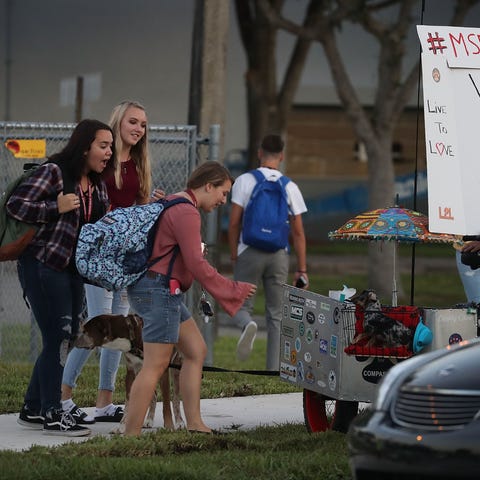 Students walk to Marjory Stoneman Douglas High...