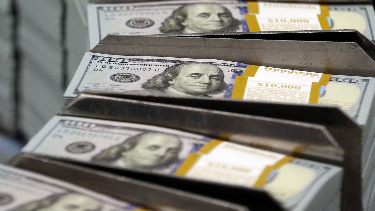 FILE - In this Sept. 24, 2013, file photo, just cut stacks of $100 bills make their way down the line at the Bureau of Engraving and Printing Western Currency Facility in Fort Worth, Texas. Big U.S. companies have been piling up cash for years, but have spent little of it on buying equipment and raising wages and other things to grow the economy. Republicans say they know how to fix this: Give companies even more money by cutting their taxes. (AP Photo/LM Otero,   File) ORG XMIT: NYBZ239