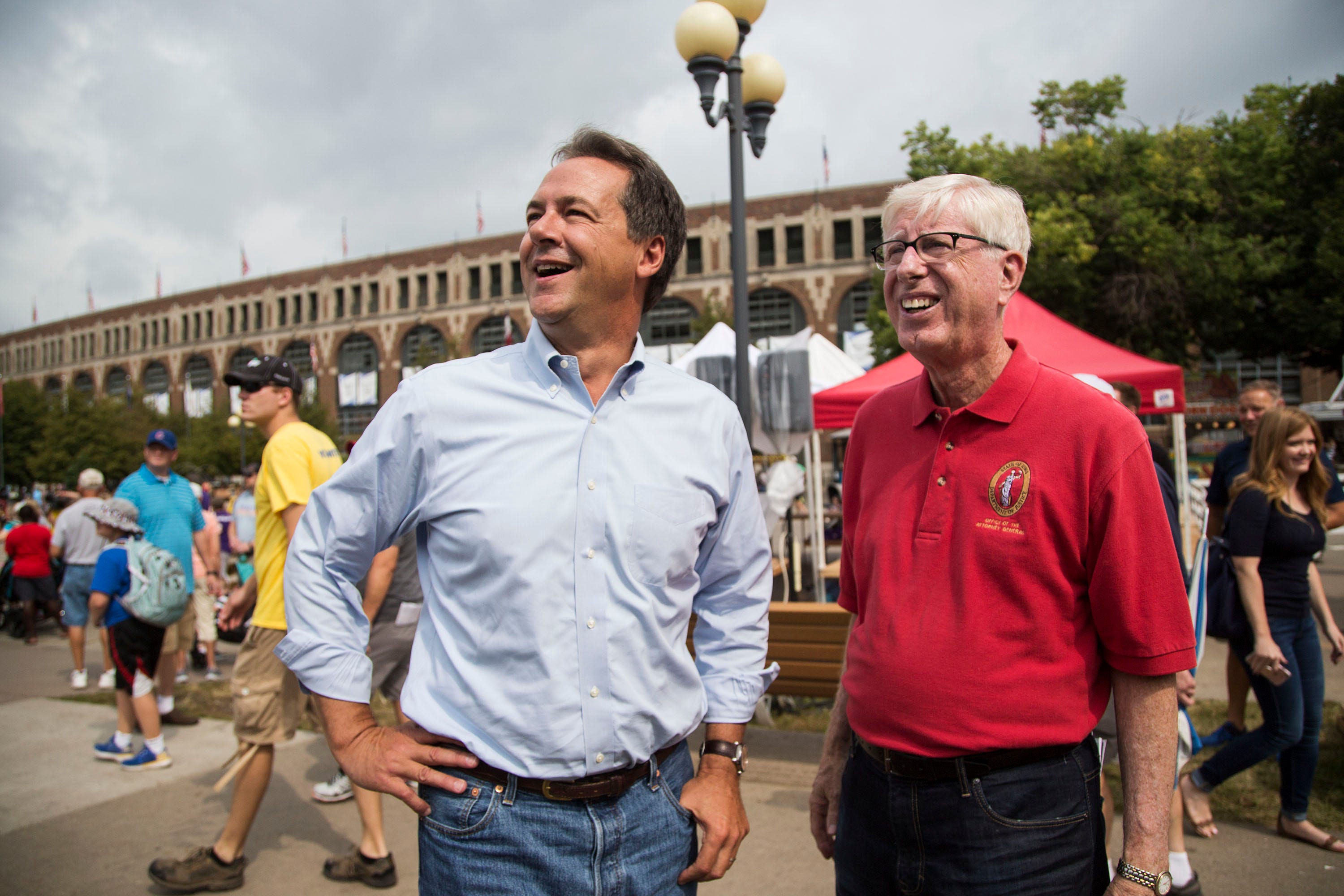 Steve Bullock, Governor of Montana, stands just off the grand concourse of the Iowa State Fair with Iowa Attorney General Tim Miller before speaking at the Des Moines Register Political Soapbox on Thursday, Aug. 16, 2018, at the Iowa State Fair. 