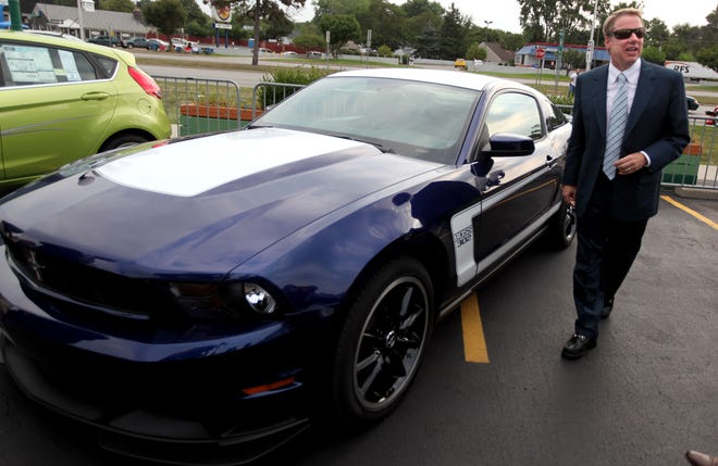 Bill Ford, executive chairman of Ford Motor Company stands in front of the 2011 Ford Mustang Boss 302 during the Woodward Dream Cruise kickoff business breakfast at Duggan's Irish Pub in Royal Oak on Aug. 20, 2010.