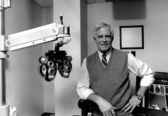 Dr. John Tanton, an ophthalmologist, in his Petoskey office in February 1989.  From the story, "has been beseeching the nation for years to make English its official language before it's too late, and to zip up its borders before the tide of illegal immigrants turns into a torrent."