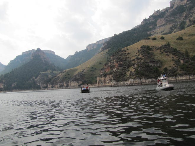 Boats use sonar to map the waterway where two men are missing and presumed drowned in the Bighorn Canyon.