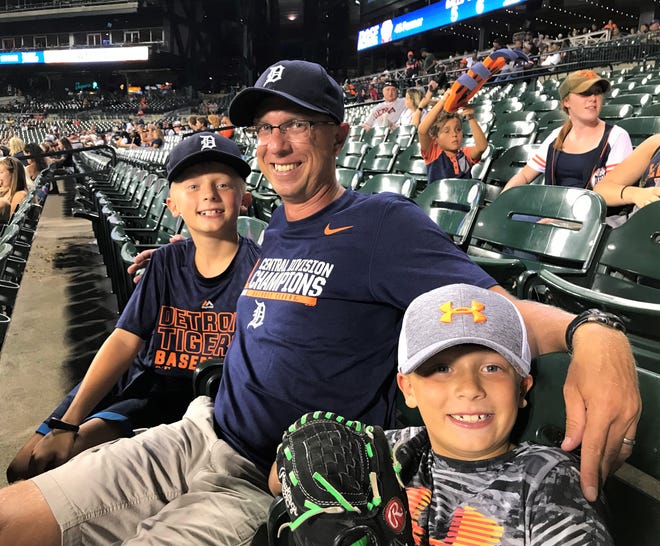 Franklin cross country coach Dave Bjorklund (middle), with his two sons Tyler (left) and Ryan (right), caught LaMarre's first Major League homer at Comerica Park.