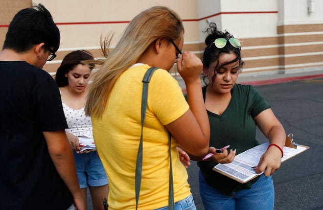 Maria Nieto, right, and Alma Romo, second from left, register people to vote in Las Vegas on Aug. 15, 2018. Democrats in Nevada are working to register and engage Latino voters ahead of this year's midterms, hoping to recreate the big wins that the state's Hispanic and immigrant community are credited with delivering two years ago.
