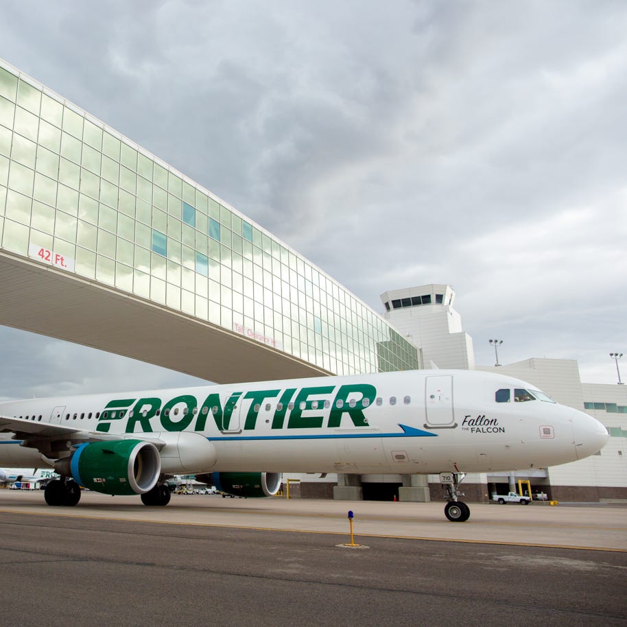 A Frontier Airbus A321 passes under the famous pedestrian bridge at  Denver International Airport on May 7, 2017.