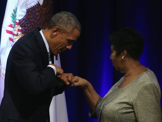 WASHINGTON, DC - FEBRUARY 27: US President Barack Obama fist bumps with singer Aretha Franklin who sung during a farwell ceremony for Attorney General Eric Holder at the Justice Department February 27, 2015 in Washington, DC. The ceremony was held to unveil the Attorney Generals official portrait and commemorate his tenure before his expected departure from the department after more than six years of service. (Photo by Mark Wilson/Getty Images)
