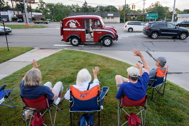 Spectators wave to a 1957 DIVCO milk truck owned by Gary Colosimo of Pittsburgh on Woodward near Normandy in Royal Oak on Aug. 16, 2018.