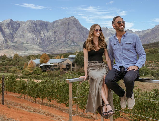 Kelly Cueto and Max Blumenthal relax in a wine region of South Africa. The couple quit their jobs to spend a year traveling.