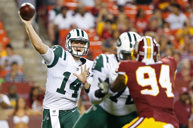 New York Jets quarterback Sam Darnold (14) passes the ball as Washington Redskins linebacker Preston Smith (94) defends in the first quarter at FedEx Field.