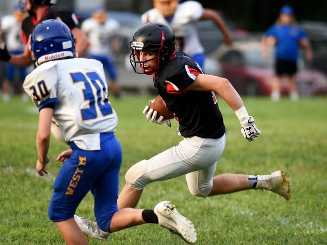Nick Losco looks for running room en route to a 50-yard touchdown reception during Roscrans' scrimmage last season against visiting West Muskingum. Losco returns as the Bishops' embark on an eight-man football season for the first time.