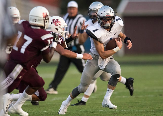 Reitz quarterback Eli Wiethop (1) attempts to run through Henderson County's defense during the Panthers' 41-35 victory at Colonel Stadium.