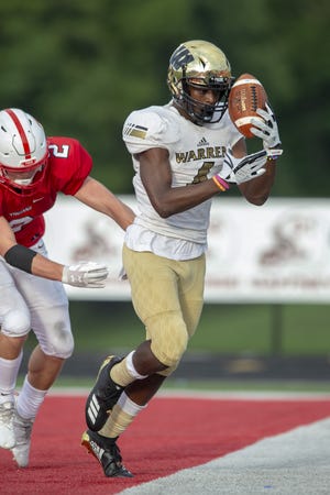 Warren Central High School senior David Bell (4) tries to gain control of the ball he intercepted in the back of the end zone before stepping out-of-bounds during the first half of action. Center Grove High School hosted Warren Central High School in IHSAA varsity football action, Friday, Aug. 17, 2018.