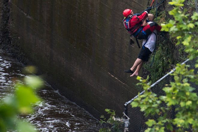 Paterson first responders rescue a man from the water at Paterson Great Falls National Historical Park on Saturday, August 18, 2018.