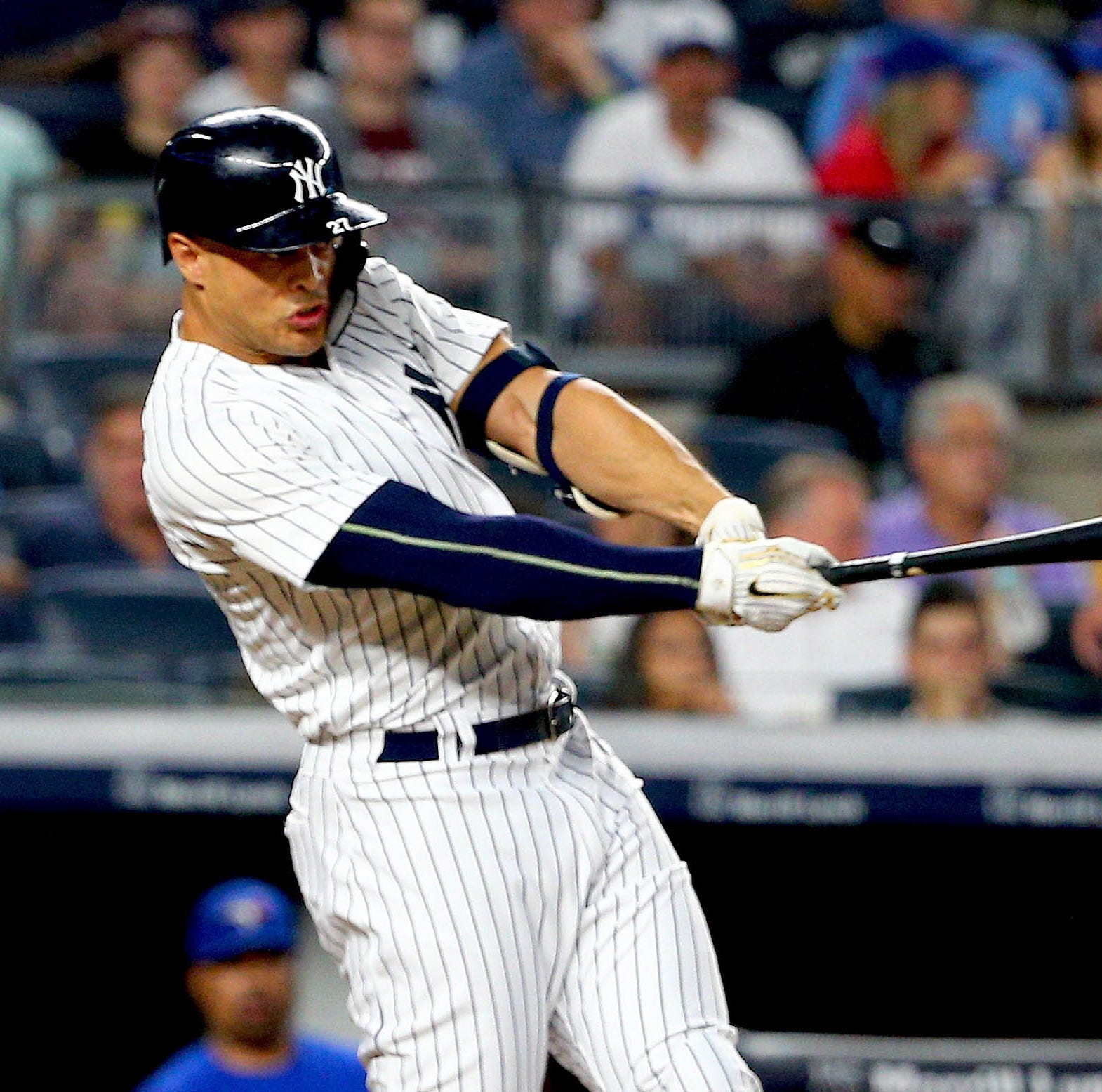 New York Yankees designated hitter Giancarlo Stanton (27) singles against the Toronto Blue Jays during the third inning at Yankee Stadium.