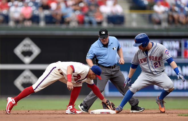 New York Mets' Todd Frazier (21) slides into second base ahead of a tag from Philadelphia Phillies' Cesar Hernandez (16) in the second inning of a baseball game, Saturday, Aug. 18, 2018, in Philadelphia.