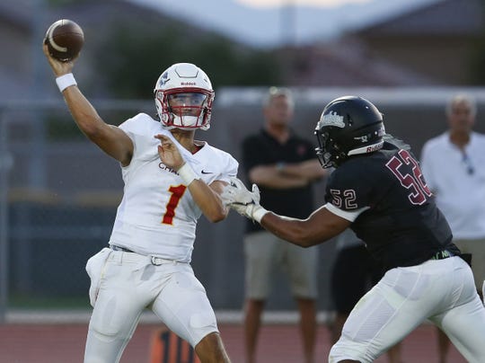 Chaparral quarterback Jack Miller (1) attempts to pass the ball before being tackled by  Hamilton Derrick Porter (52) during a high school football game at Hamilton in Chandler on August 17, 2018. #hsfb
