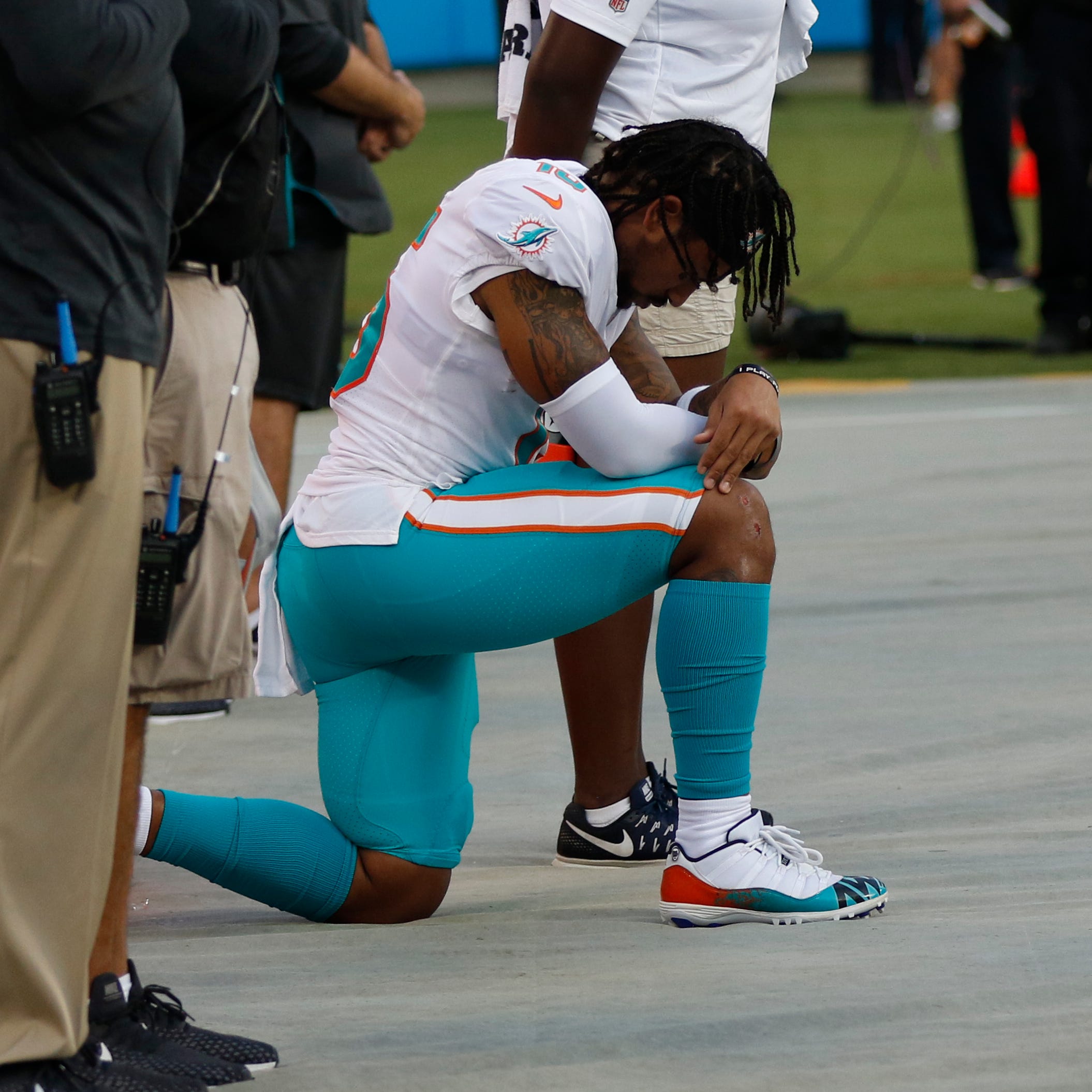 Miami Dolphins' Albert Wilson (15) kneels during the national anthem before a preseason NFL football game against the Carolina Panthers in Charlotte, N.C., Friday, Aug. 17, 2018.