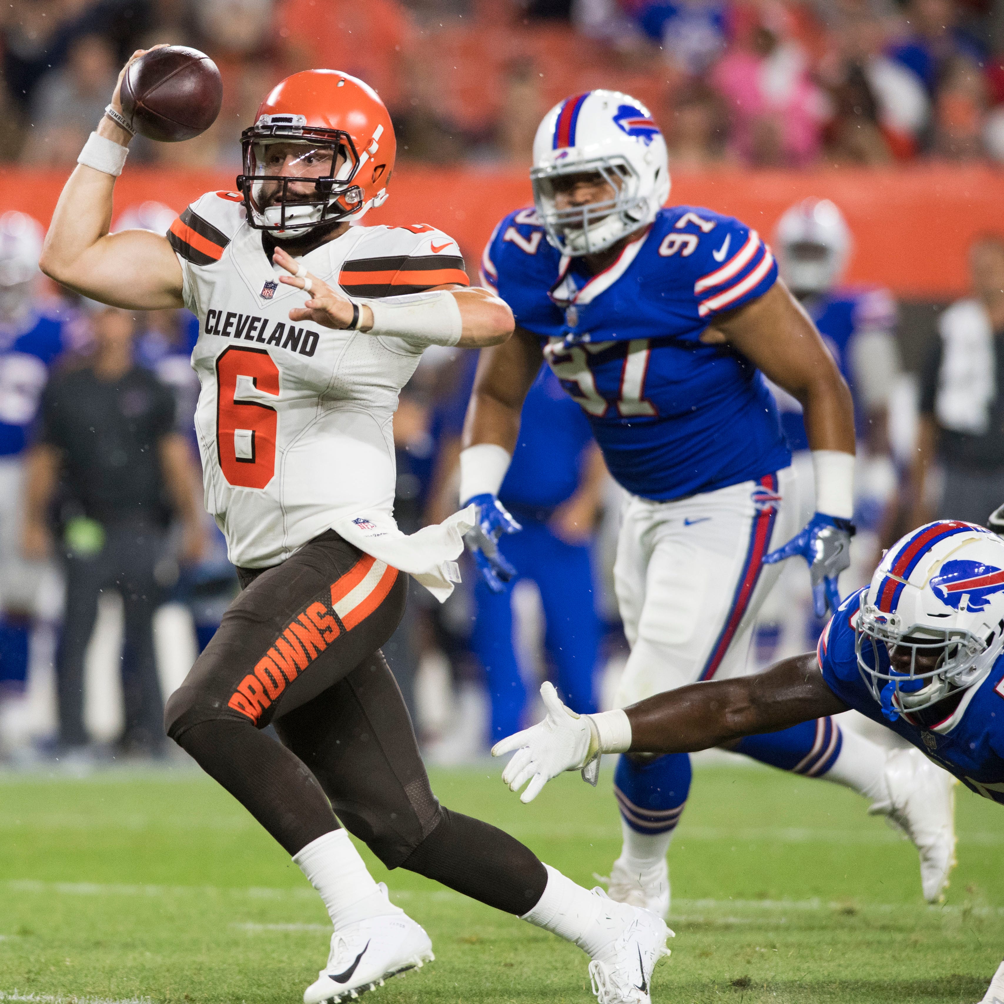 Cleveland Browns quarterback Baker Mayfield (6) scrambles from Buffalo Bills defensive end Mike Love (56) during the second half at FirstEnergy Stadium.
