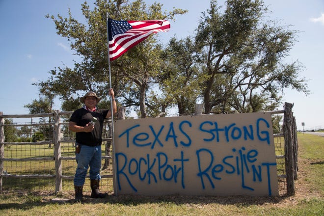 Carlos Casas stands in front of his sign on Sunday, August, 19, 2018  outside his home in Rockport. He made it after Hurricane Harvey made landfall there and it's stood as a message of hope for many residents.