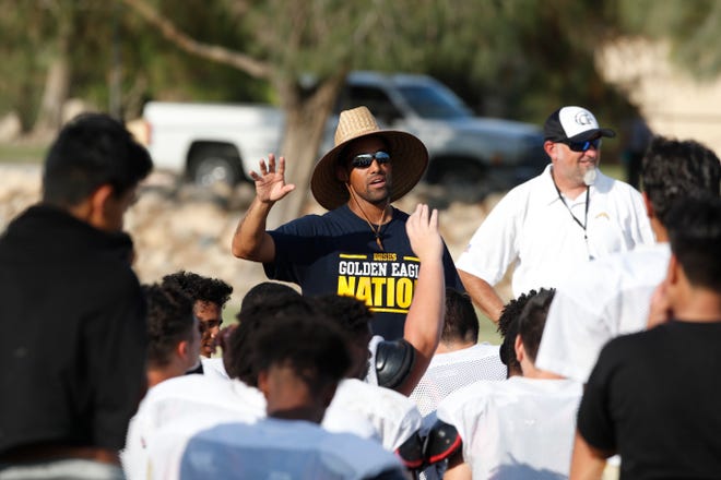 Desert Hot Springs football coach Errol Wilson speaks with his team during a practice this month.