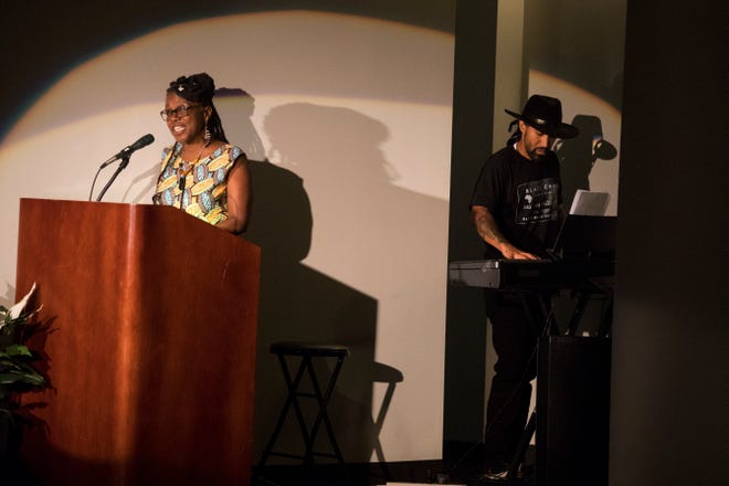 Local artist TAHIRA, left, and local singer/songwriter Jae Street Jr. perform during their multimedia performance of Unbroken Spirit Sunday at the Delaware Art Museum. The performance focuses on the occupation of Wilmington by the U.S. National Guard in 1968.