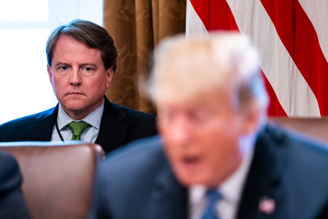 White House counsel Don McGahn (L) listens to President Donald J. Trump speak to the media before meeting with members of his administration in the Cabinet Room of the White House Washington, DC, USA 21 June 2018, (reissued 19 August 2018). (EPA-EFE)