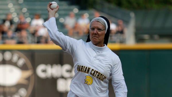 Sister Mary Jo Sobieck throws out a ceremonial...