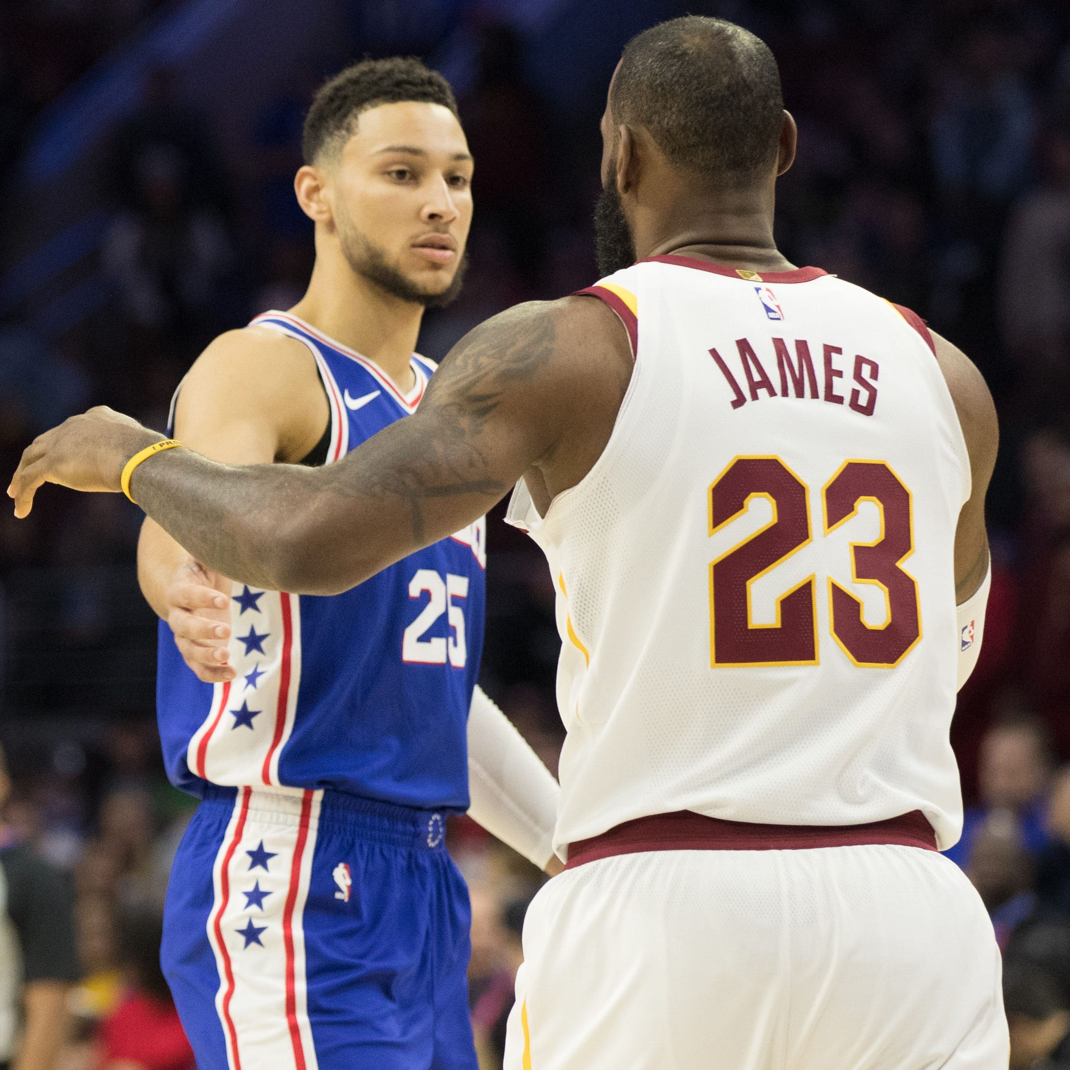 Philadelphia 76ers guard Ben Simmons (25) and Cleveland Cavaliers forward LeBron James (23) during a game at Wells Fargo Center.