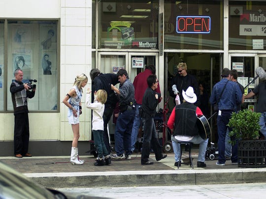 Asia Argento, second from left, gives direction during the filming of the movie "The Heart is Deceitful Above All Things" on Gay Street in downtown Knoxville on Friday, Oct. 3, 2003. In front of her is one of the twin actors, Dylan or Cole Sprouse, who play her son in the film.