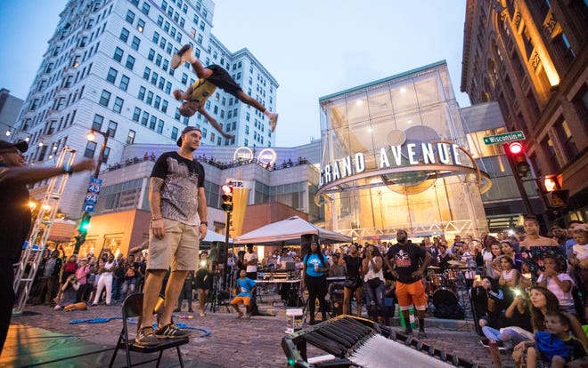 Jeremy Witter of Milwaukee attends a  Night Market event in 2018. He volunteered to stand as Allen Grant, 11, jumps over him. Grant is a part of a group called Milwaukee Flyers that started in 2005.