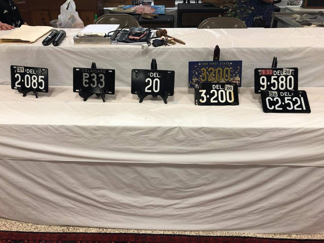 A file photo of an auction with five low-digit tags for sale, including number 20, which brought $410,000.