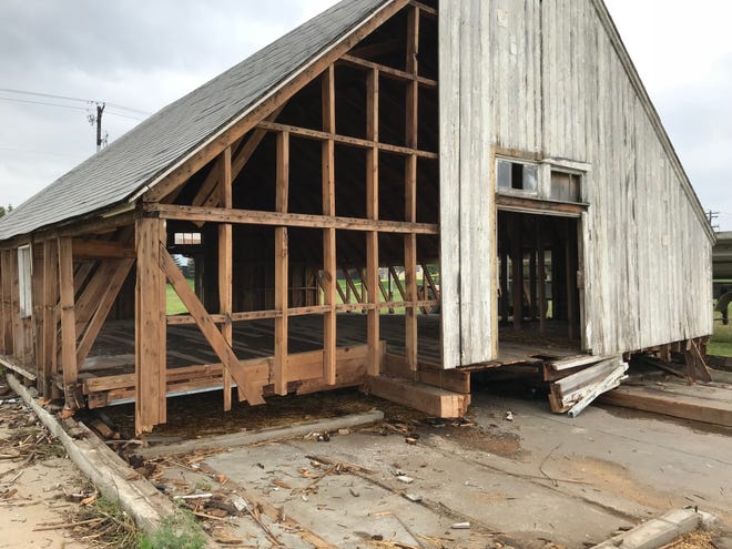 Workers have begun removing wood from the barn at Lake Lorraine. Developers plan to use the wood to memorialize the property's history as a farm.