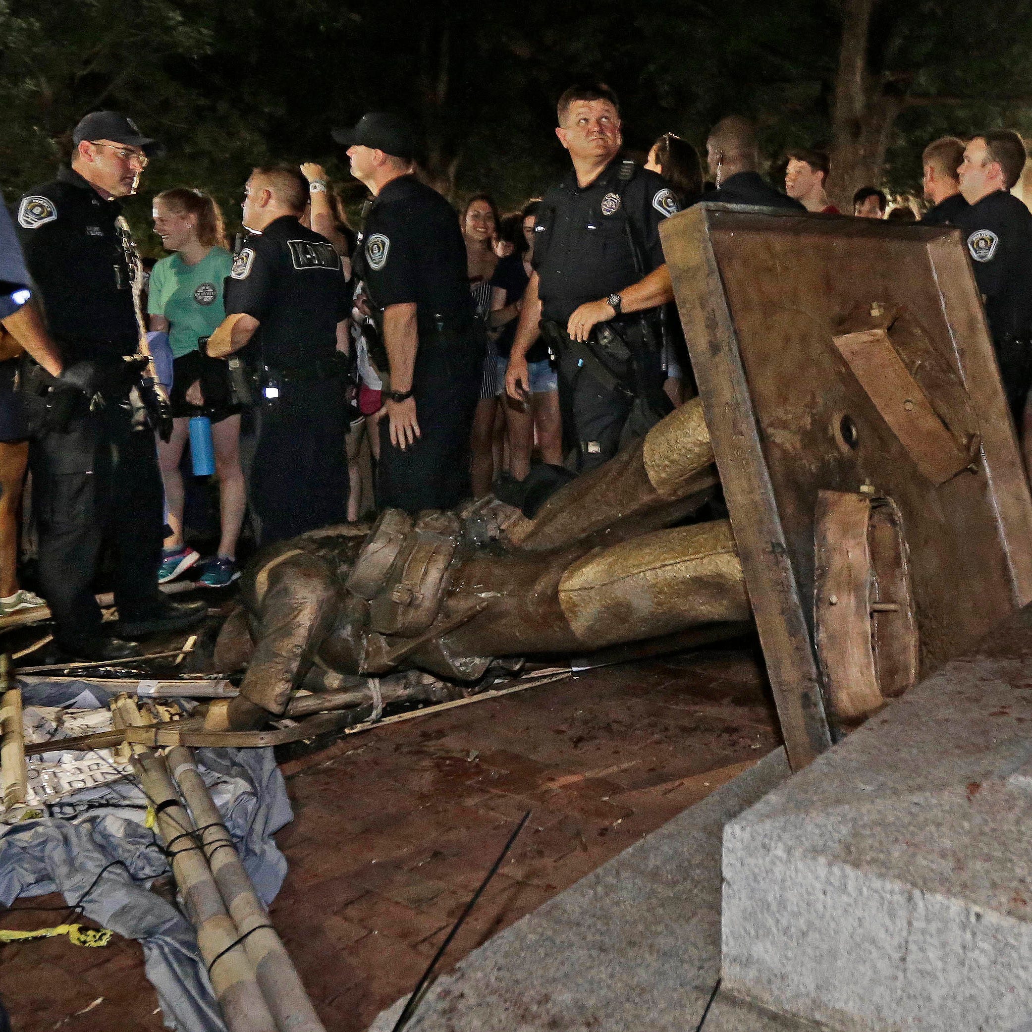 Police stand guard after the confederate statue known as 
