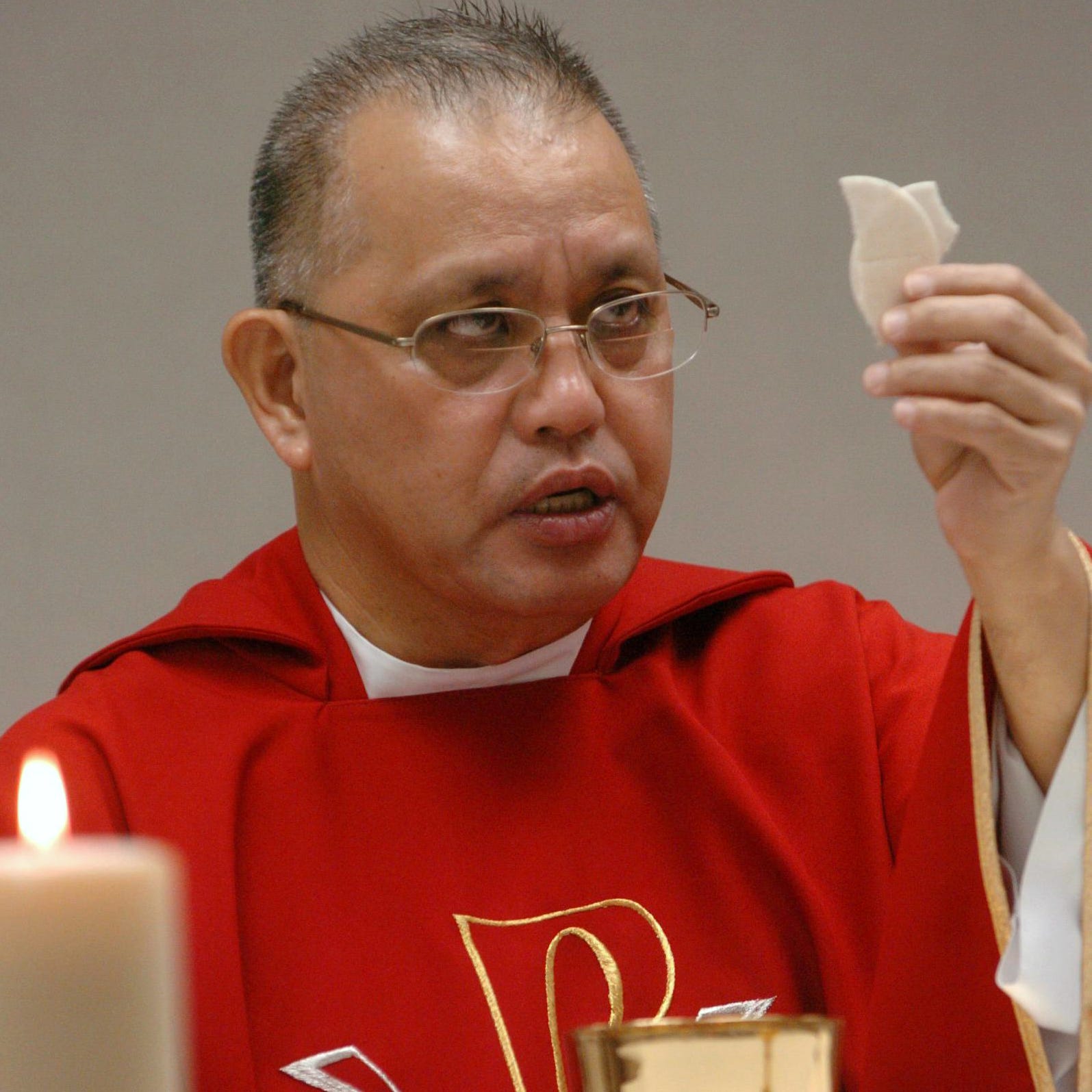 The Rev. Edmundo Paredes prepares for communion June 5, 2008, at St. Cecilia Catholic Church in Dallas. Paredes, a Texas priest now accused of molesting teens and stealing from his parish, has gone missing.