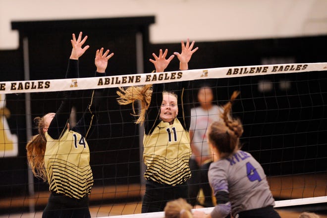Abilene High's Sarah Cox (11) tries to block a Wylie shot during the nondistrict match Aug. 21 at Eagle Gym. AHS won the match 3-0. Cox is one of three returning players for the Lady Eagles this season.